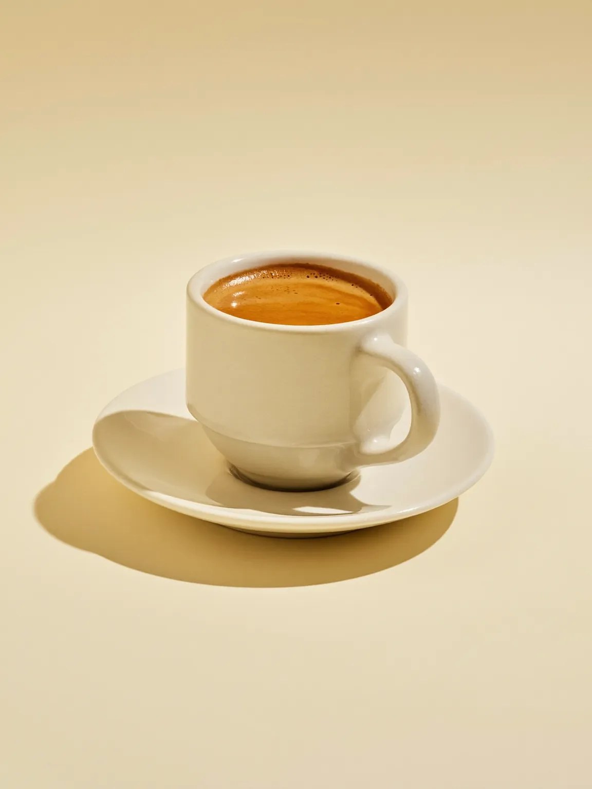 An espresso in a small dark cup